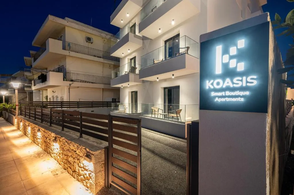 The Koasis building and illuminated sign at dusk